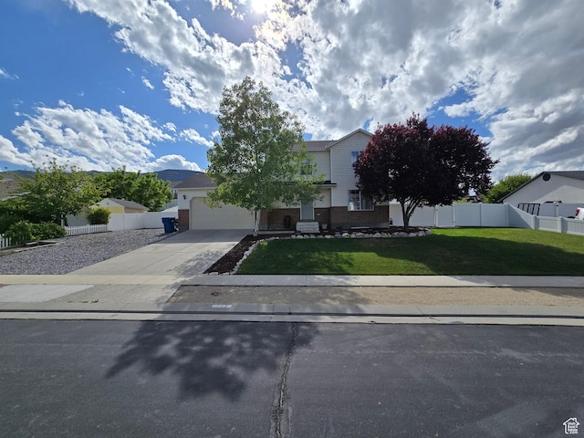 4043 S Lake Vista Dr, Saratoga Springs, UT 84045 - view of property hidden behind natural elements featuring concrete driveway, brick siding, and a garage