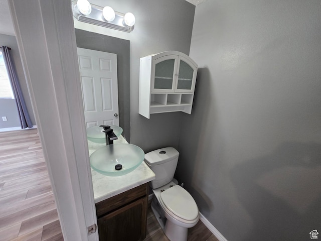 4043 S Lake Vista Dr, Saratoga Springs, UT 84045 - half bathroom featuring vanity, wood finished floors, baseboards, and toilet
