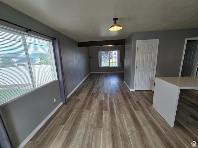 4043 S Lake Vista Dr, Saratoga Springs, UT 84045 - unfurnished dining area featuring dark wood-style floors and baseboards
