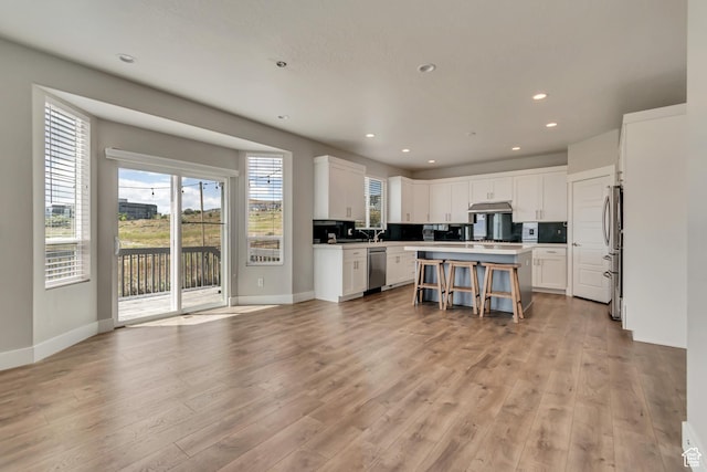 3727 N 900 W, Lehi, UT 84043 - kitchen featuring stainless steel appliances, a kitchen island, white cabinetry, under cabinet range hood, and recessed lighting
