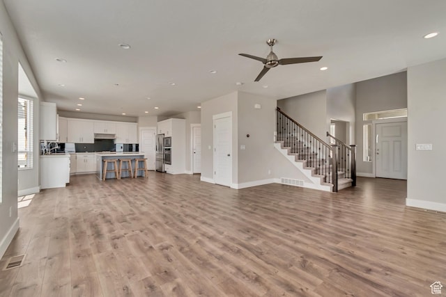 3727 N 900 W, Lehi, UT 84043 - unfurnished living room with stairs, baseboards, recessed lighting, light wood-style flooring, and ceiling fan