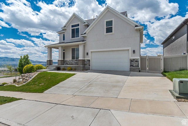 3727 N 900 W, Lehi, UT 84043 - view of front facade featuring a garage, stone siding, covered porch, a gate, and a mountain view