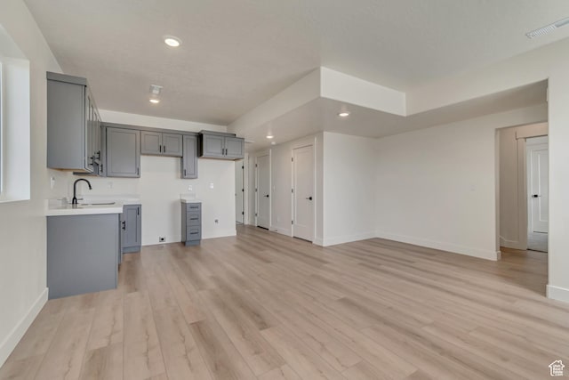3727 N 900 W, Lehi, UT 84043 - unfurnished living room with baseboards, recessed lighting, light wood-type flooring, and a sink