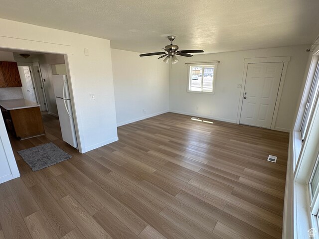 4688 S 200 E, Washington Terrace, UT 84405 - unfurnished living room with ceiling fan, wood finished floors, and baseboards