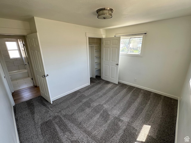 4688 S 200 E, Washington Terrace, UT 84405 - unfurnished bedroom with dark carpet, multiple windows, a closet, and baseboards