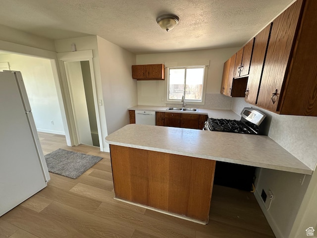 4688 S 200 E, Washington Terrace, UT 84405 - kitchen featuring white appliances, a sink, a peninsula, light countertops, and light wood-type flooring