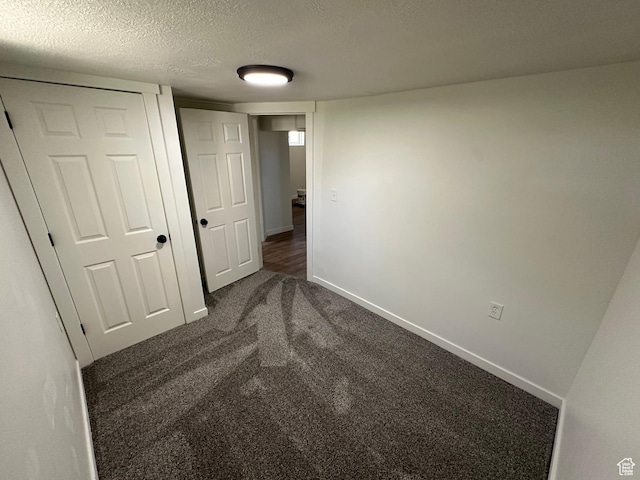4688 S 200 E, Washington Terrace, UT 84405 - unfurnished bedroom with dark carpet, a textured ceiling, and baseboards