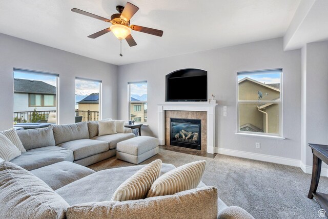 414 W Kit Fox Dr, Saratoga Springs, UT 84045 - carpeted living room featuring baseboards, a tile fireplace, and a ceiling fan