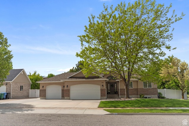 890 E 20 N, Smithfield, UT 84335 - ranch-style home with an attached garage, driveway, and brick siding