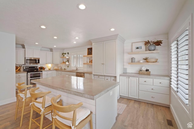 890 E 20 N, Smithfield, UT 84335 - kitchen with open shelves, stainless steel appliances, light wood-style floors, white cabinets, and recessed lighting