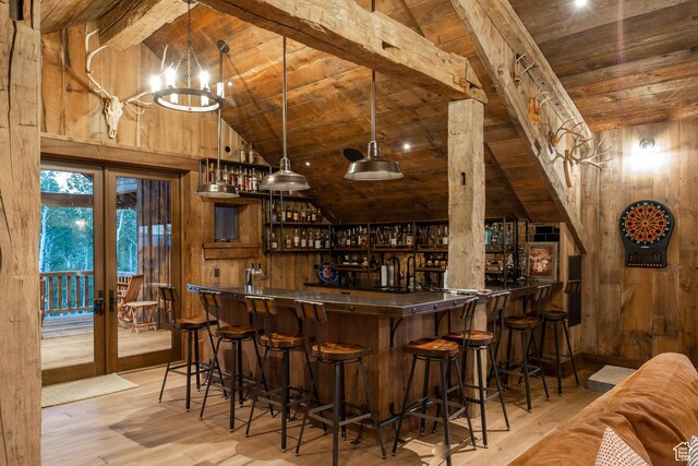 11042 E Wild Elk Mdw, Heber City, UT 84032 - indoor wet bar with wooden ceiling with exposed beams, french doors, wooden walls, wood finished floors, and high vaulted ceiling
