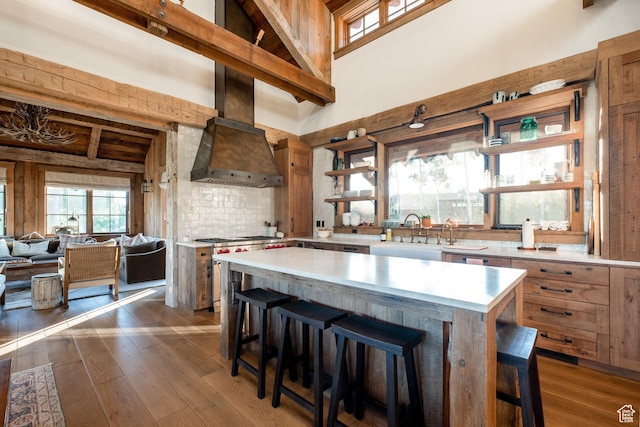 11042 E Wild Elk Mdw, Heber City, UT 84032 - kitchen with a sink, light countertops, high vaulted ceiling, a breakfast bar, and dark wood-style floors