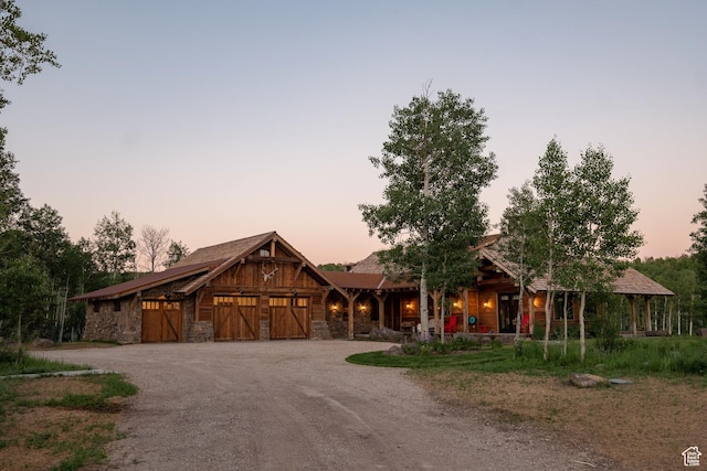 11042 E Wild Elk Mdw, Heber City, UT 84032 - chalet / cabin featuring driveway, stone siding, and an attached garage
