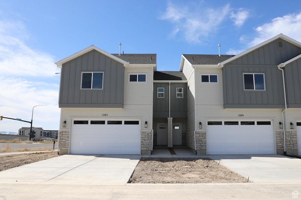 1905 E 1420 N, Spanish Fork, UT 84660 - view of front of home featuring an attached garage, board and batten siding, driveway, and stone siding