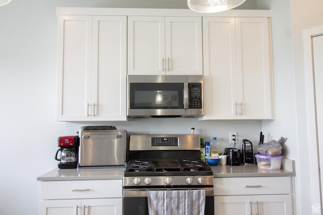 3717 S 3250 W Unit E33, West Haven, UT 84401 - kitchen with stainless steel appliances, light countertops, and white cabinets