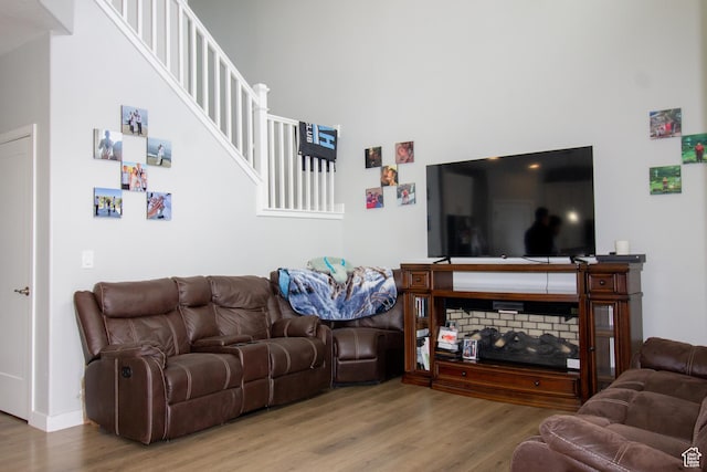 3717 S 3250 W Unit E33, West Haven, UT 84401 - living area featuring wood finished floors, a towering ceiling, baseboards, and stairway