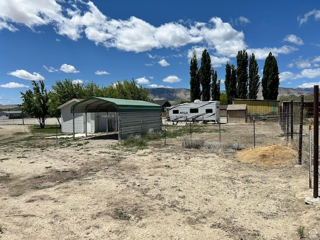 545 E Molen Rd, Ferron, UT 84523 - view of yard with a carport, an outdoor structure, and a mountain view