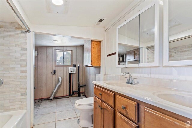 660 S Coleman St, Tooele, UT 84074 - full bathroom featuring toilet, double vanity, tile patterned floors, wood walls, and bathtub / shower combination