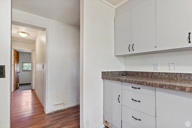 660 S Coleman St, Tooele, UT 84074 - kitchen featuring wood finished floors, dark countertops, and white cabinetry