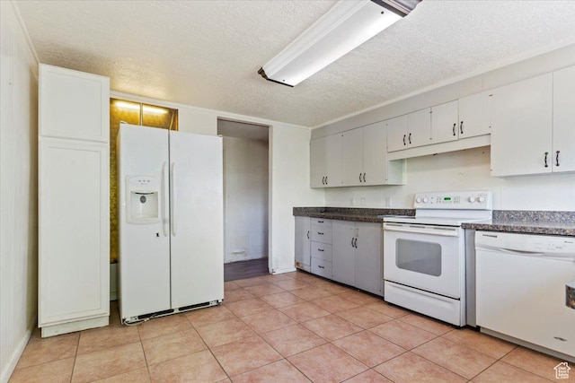 660 S Coleman St, Tooele, UT 84074 - kitchen with white appliances, dark countertops, a textured ceiling, white cabinets, and light tile patterned floors
