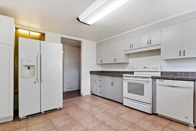 660 S Coleman St, Tooele, UT 84074 - kitchen featuring white appliances, a textured ceiling, dark countertops, light tile patterned floors, and white cabinets