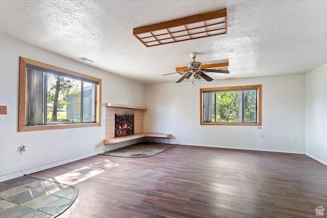 660 S Coleman St, Tooele, UT 84074 - unfurnished living room featuring a lit fireplace, wood finished floors, a textured ceiling, ceiling fan, and baseboards