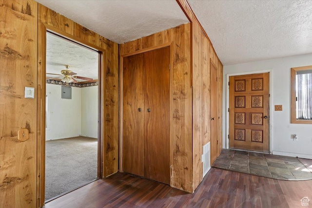 660 S Coleman St, Tooele, UT 84074 - foyer featuring a textured ceiling, wood walls, dark wood finished floors, ceiling fan, and electric panel