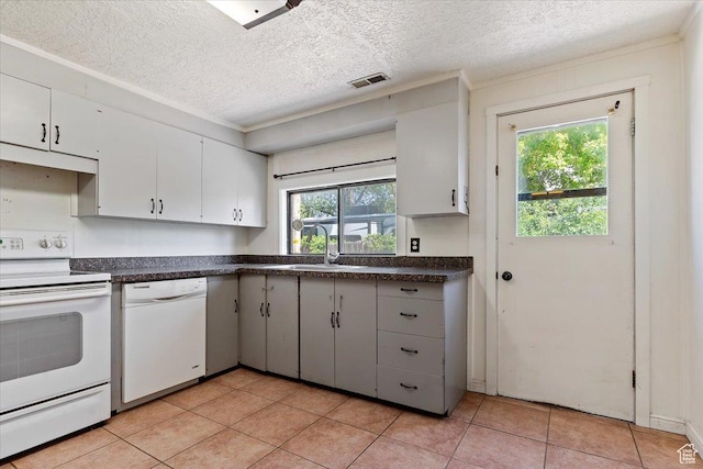 660 S Coleman St, Tooele, UT 84074 - kitchen with white appliances, dark countertops, a sink, a textured ceiling, and light tile patterned floors