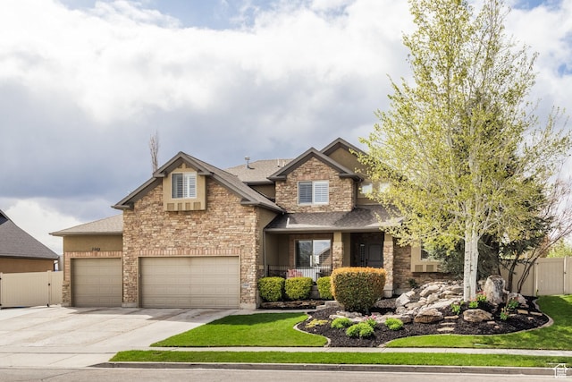 2949 W Hayden Ridge Way, Riverton, UT 84065 - craftsman-style home with stone siding, driveway, a shingled roof, and a garage