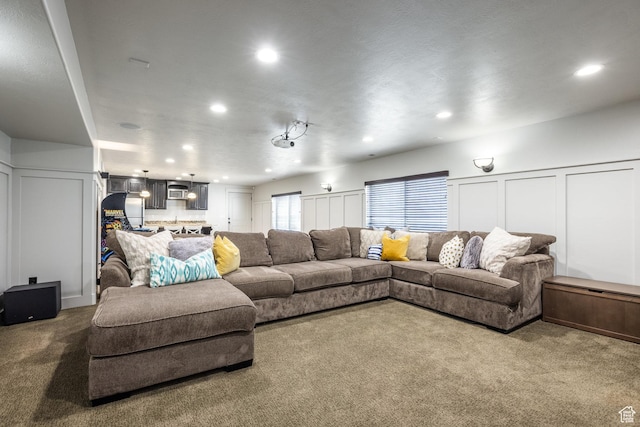 2949 W Hayden Ridge Way, Riverton, UT 84065 - living room featuring dark colored carpet, recessed lighting, and a decorative wall