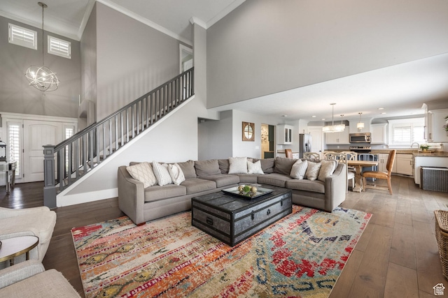 2949 W Hayden Ridge Way, Riverton, UT 84065 - living room with a high ceiling, a chandelier, stairs, wood-type flooring, and crown molding