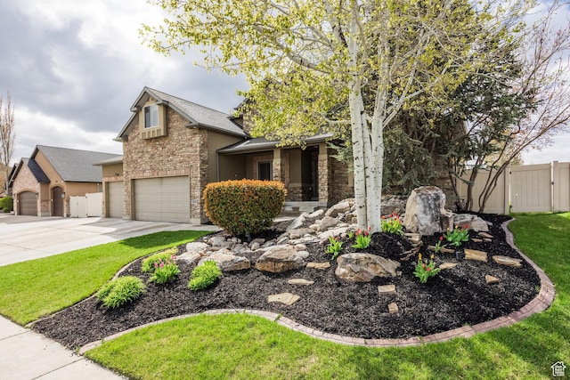 2949 W Hayden Ridge Way, Riverton, UT 84065 - view of front of house featuring stone siding, a gate, driveway, and an attached garage