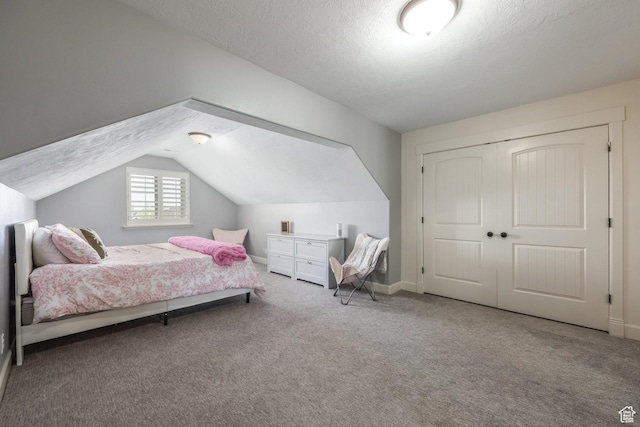 2949 W Hayden Ridge Way, Riverton, UT 84065 - bedroom with carpet floors, vaulted ceiling, a closet, baseboards, and a textured ceiling