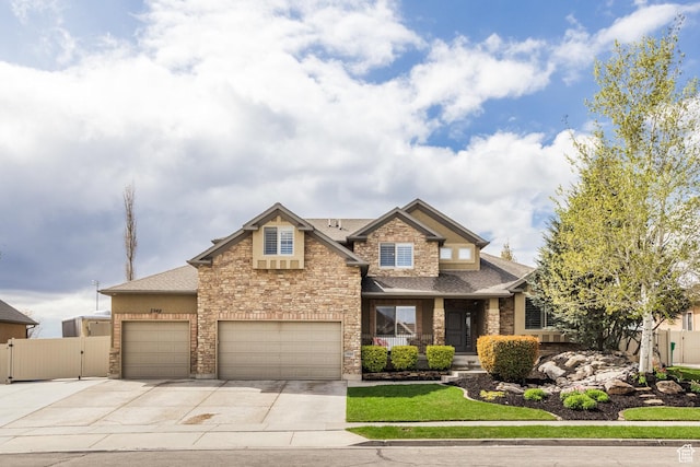 2949 W Hayden Ridge Way, Riverton, UT 84065 - craftsman inspired home featuring a gate, a shingled roof, driveway, covered porch, and stone siding