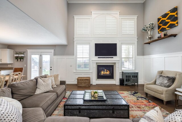2949 W Hayden Ridge Way, Riverton, UT 84065 - living area featuring a decorative wall, a glass covered fireplace, a wainscoted wall, and wood finished floors