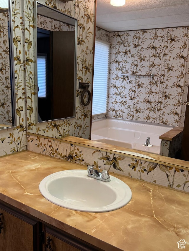 184 N 3rd E, Manila, UT 84046 - full bath with wallpapered walls, a garden tub, healthy amount of natural light, and vanity