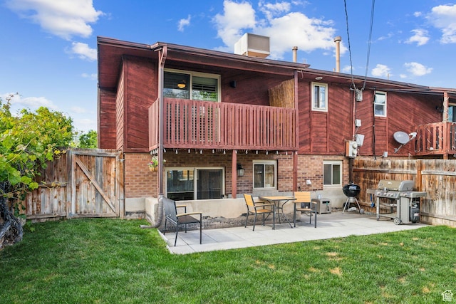 518 E 3955 S, Millcreek, UT 84107 - rear view of house featuring a gate, a balcony, a patio, and brick siding