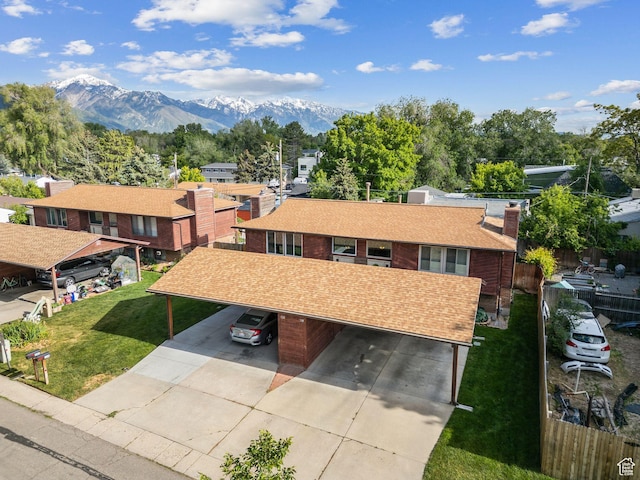 518 E 3955 S, Millcreek, UT 84107 - view of front facade featuring a mountain view, a carport, driveway, and a shingled roof