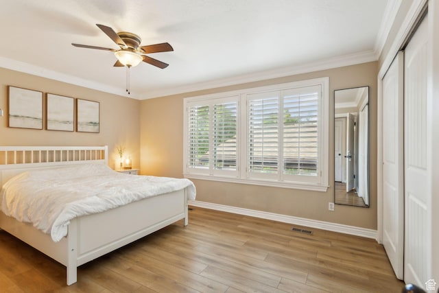 518 E 3955 S, Millcreek, UT 84107 - bedroom featuring baseboards, crown molding, light wood finished floors, a closet, and ceiling fan
