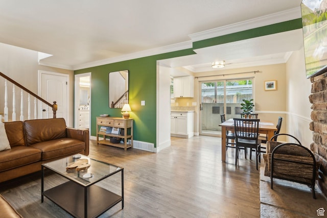 518 E 3955 S, Millcreek, UT 84107 - living room with stairway, light wood-style floors, crown molding, and baseboards