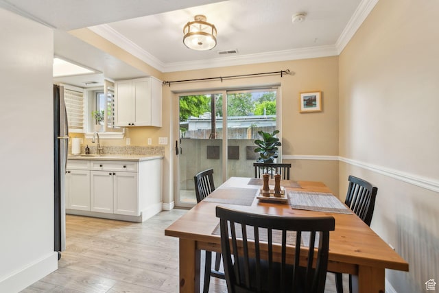 518 E 3955 S, Millcreek, UT 84107 - dining room featuring ornamental molding, light wood-style floors, and baseboards