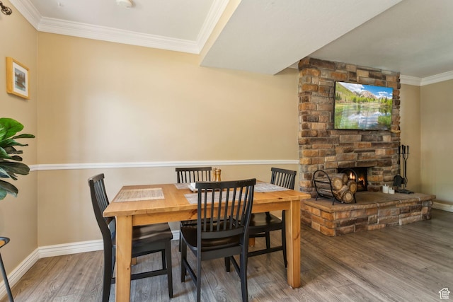 518 E 3955 S, Millcreek, UT 84107 - dining area featuring wood finished floors, baseboards, a fireplace, and crown molding
