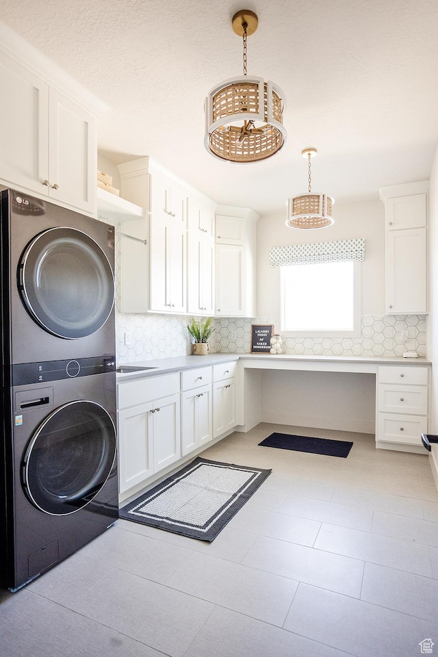778 N 780th St W, American Fork, UT 84003 - laundry area with stacked washer / drying machine, cabinet space, and a desk