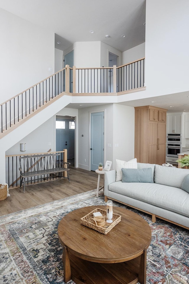 778 N 780th St W, American Fork, UT 84003 - living area with a high ceiling, wood finished floors, stairs, and recessed lighting