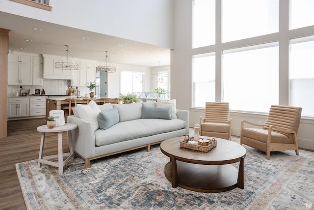 778 N 780th St W, American Fork, UT 84003 - living area featuring wood finished floors, recessed lighting, a chandelier, and a high ceiling