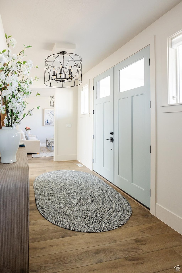 778 N 780th St W, American Fork, UT 84003 - foyer entrance featuring wood finished floors, a chandelier, and baseboards
