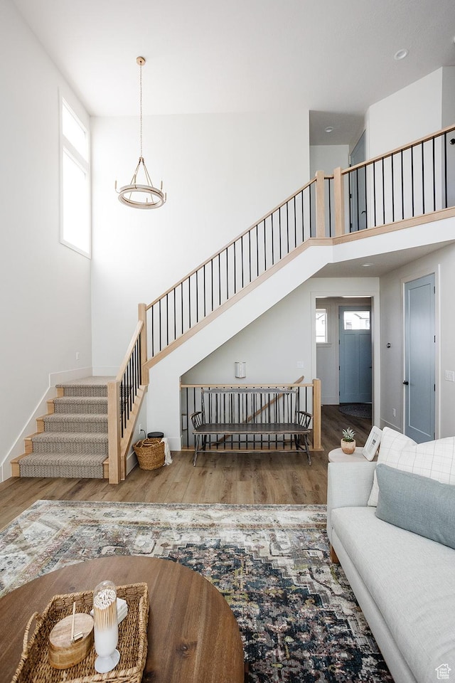 778 N 780th St W, American Fork, UT 84003 - living area with stairs, a towering ceiling, wood finished floors, and baseboards