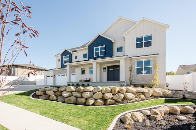 778 N 780th St W, American Fork, UT 84003 - view of front facade with board and batten siding, a garage, concrete driveway, and covered porch