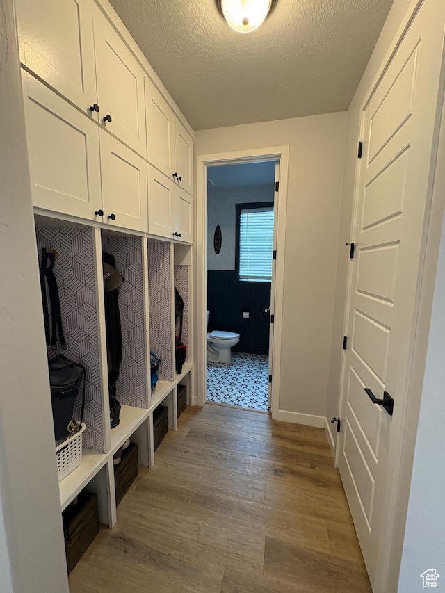2323 W Thomas Ct, Syracuse, UT 84075 - mudroom with wood finished floors, baseboards, and a textured ceiling