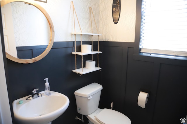 2323 W Thomas Ct, Syracuse, UT 84075 - half bathroom with a sink, toilet, and wainscoting